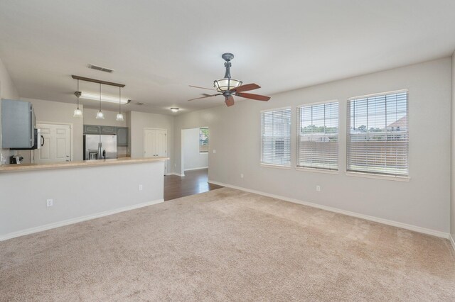 715 Presscott St, Crestview, FL 32536 - unfurnished living room with dark colored carpet and a ceiling fan