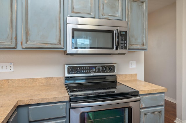 715 Presscott St, Crestview, FL 32536 - kitchen featuring stainless steel appliances, light countertops, and dark wood finished floors