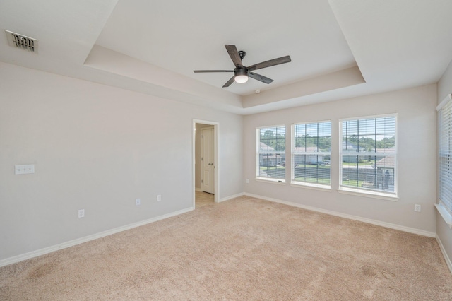 715 Presscott St, Crestview, FL 32536 - empty room with a ceiling fan, light colored carpet, and a tray ceiling
