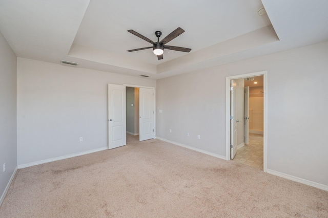 715 Presscott St, Crestview, FL 32536 - unfurnished bedroom with a raised ceiling, light carpet, and a ceiling fan