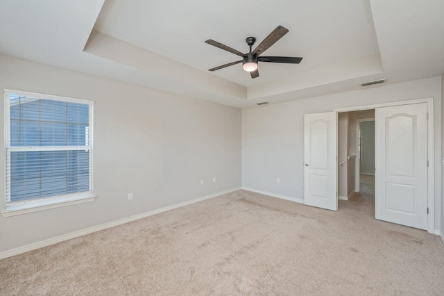 715 Presscott St, Crestview, FL 32536 - unfurnished bedroom with a tray ceiling, carpet floors, and a ceiling fan
