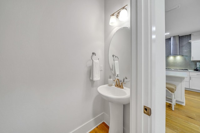 386 Grande Pointe Cir, Inlet Beach, FL 32461 - bathroom with decorative backsplash and wood finished floors
