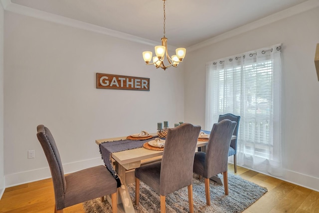 386 Grande Pointe Cir, Inlet Beach, FL 32461 - dining area with a chandelier, ornamental molding, and light wood-style floors