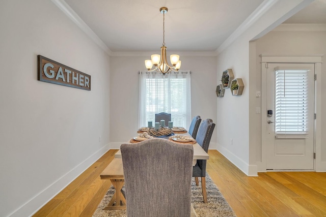 386 Grande Pointe Cir, Inlet Beach, FL 32461 - dining area featuring a chandelier, light wood-type flooring, and crown molding