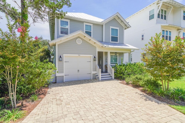 386 Grande Pointe Cir, Inlet Beach, FL 32461 - view of front of property featuring a garage, covered porch, decorative driveway, and a metal roof