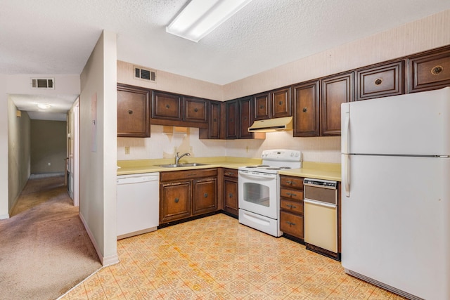 3871 Indian Trl Unit 3E, Destin, FL 32541 - kitchen featuring white appliances, under cabinet range hood, light countertops, a textured ceiling, and dark brown cabinets