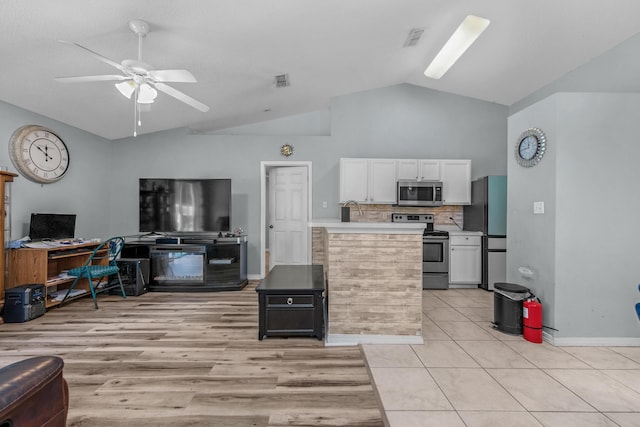 118 Cabana Way, Crestview, FL 32536 - kitchen featuring appliances with stainless steel finishes, open floor plan, white cabinetry, a ceiling fan, and light countertops