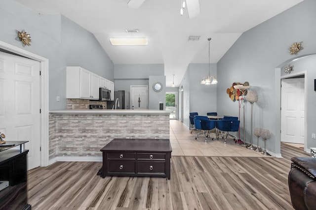 118 Cabana Way, Crestview, FL 32536 - kitchen featuring stainless steel appliances, lofted ceiling, white cabinetry, a peninsula, and a ceiling fan