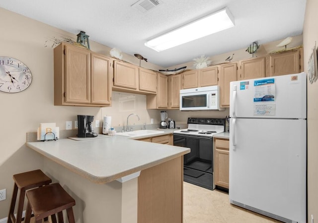 2396 Scenic Gulf Dr Unit 210, Miramar Beach, FL 32550 - kitchen featuring white appliances, light brown cabinets, a peninsula, light countertops, and a kitchen bar