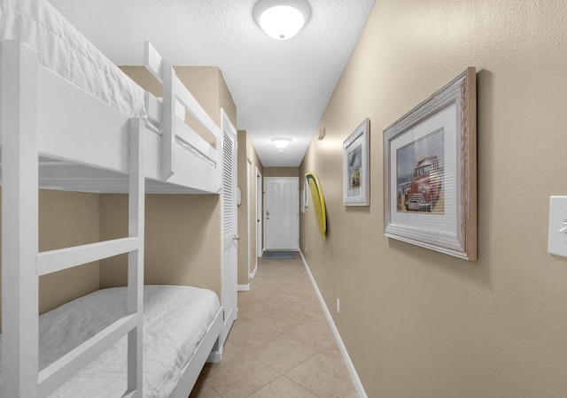 2396 Scenic Gulf Dr Unit 210, Miramar Beach, FL 32550 - hall with light tile patterned floors and a textured ceiling