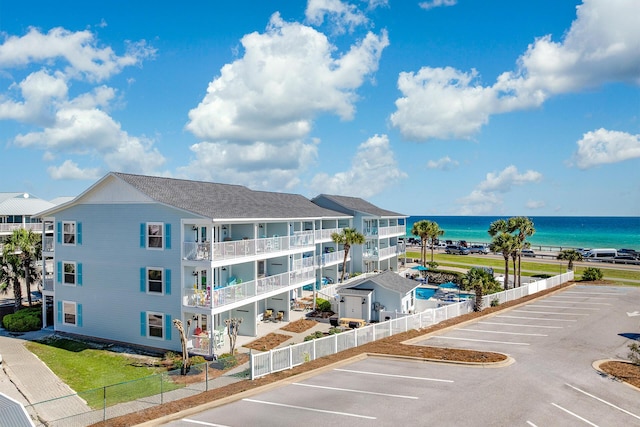 2396 Scenic Gulf Dr Unit 210, Miramar Beach, FL 32550 - view of building exterior with uncovered parking and a water view