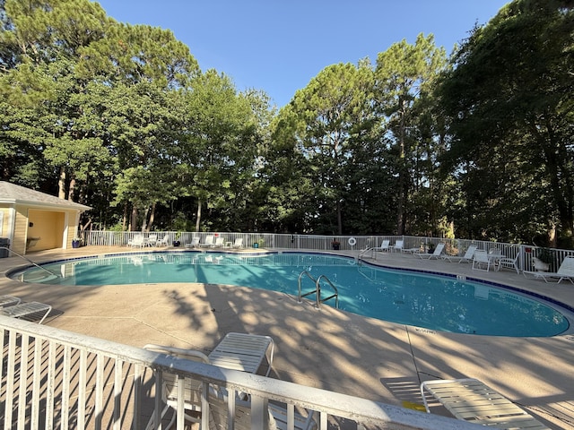 200 Sandestin Ln Unit 612, Miramar Beach, FL 32550 - community pool with a patio area and view of scattered trees