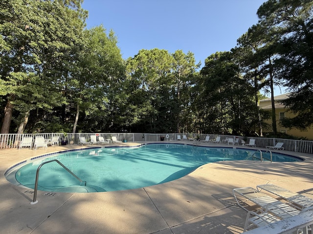200 Sandestin Ln Unit 612, Miramar Beach, FL 32550 - community pool featuring a patio area and view of wooded area