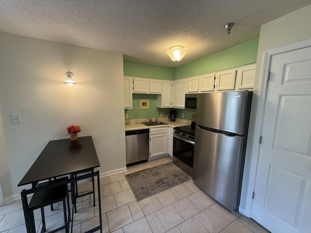 200 Sandestin Ln Unit 612, Miramar Beach, FL 32550 - kitchen with appliances with stainless steel finishes, white cabinets, light countertops, and a textured ceiling
