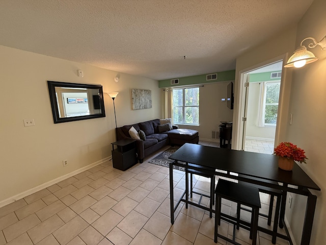 200 Sandestin Ln Unit 612, Miramar Beach, FL 32550 - living room with a textured ceiling and light tile patterned floors