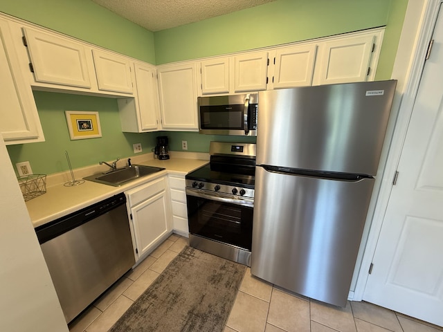 200 Sandestin Ln Unit 612, Miramar Beach, FL 32550 - kitchen featuring appliances with stainless steel finishes, white cabinetry, light countertops, and a textured ceiling