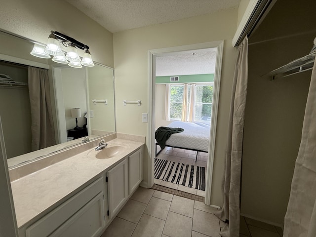 200 Sandestin Ln Unit 612, Miramar Beach, FL 32550 - full bathroom featuring a textured ceiling, tile patterned flooring, vanity, and ensuite bath