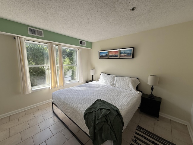 200 Sandestin Ln Unit 612, Miramar Beach, FL 32550 - bedroom with a textured ceiling and tile patterned floors