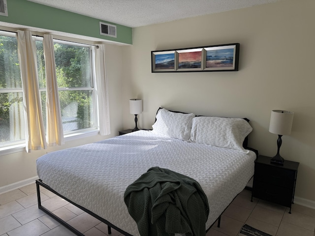200 Sandestin Ln Unit 612, Miramar Beach, FL 32550 - bedroom featuring light tile patterned floors and a textured ceiling