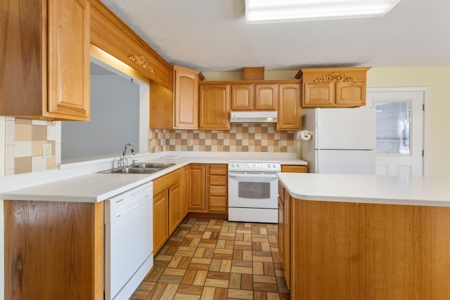 702 Beachcomber Dr, Lynn Haven, FL 32444 - kitchen with white appliances, under cabinet range hood, light countertops, and tasteful backsplash
