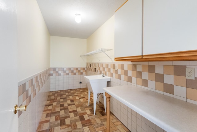 702 Beachcomber Dr, Lynn Haven, FL 32444 - washroom featuring tile walls and a wainscoted wall