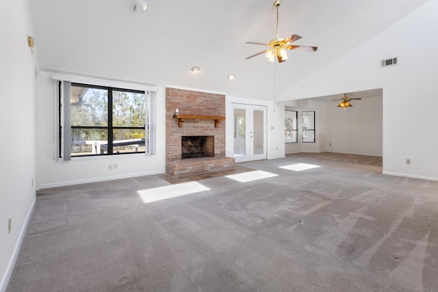 702 Beachcomber Dr, Lynn Haven, FL 32444 - unfurnished living room with ceiling fan, carpet, high vaulted ceiling, a fireplace, and french doors