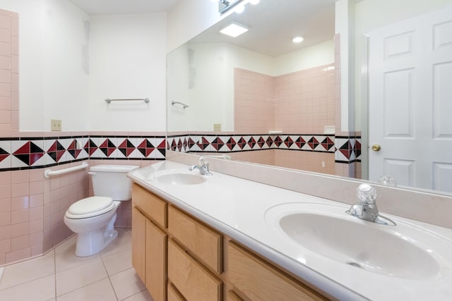 702 Beachcomber Dr, Lynn Haven, FL 32444 - full bathroom with tile patterned flooring, double vanity, tile walls, and a wainscoted wall