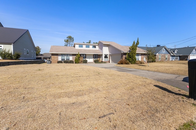 702 Beachcomber Dr, Lynn Haven, FL 32444 - mid-century inspired home with concrete driveway, an attached garage, and a residential view