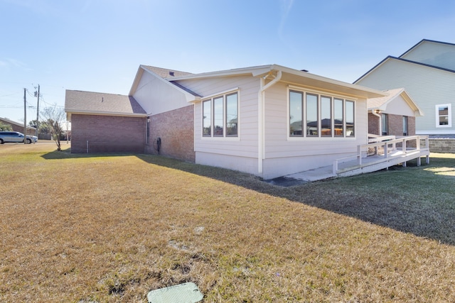 702 Beachcomber Dr, Lynn Haven, FL 32444 - view of side of property with a lawn and brick siding
