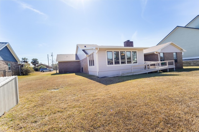 702 Beachcomber Dr, Lynn Haven, FL 32444 - back of property with a chimney and a wooden deck