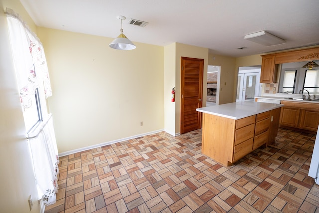 702 Beachcomber Dr, Lynn Haven, FL 32444 - kitchen featuring light countertops, a kitchen island, and hanging light fixtures