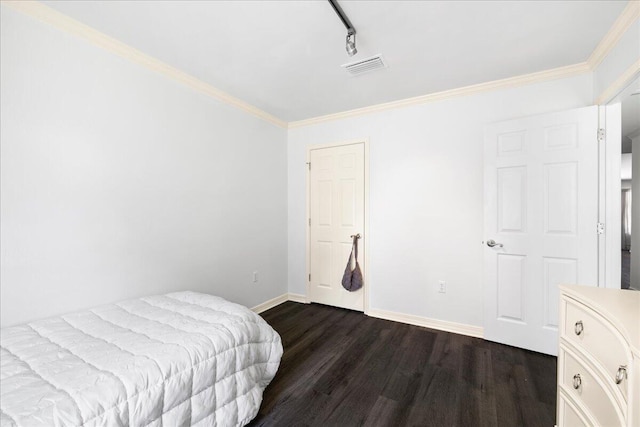 3928 Mesa Rd, Destin, FL 32541 - bedroom featuring dark wood finished floors, rail lighting, and crown molding