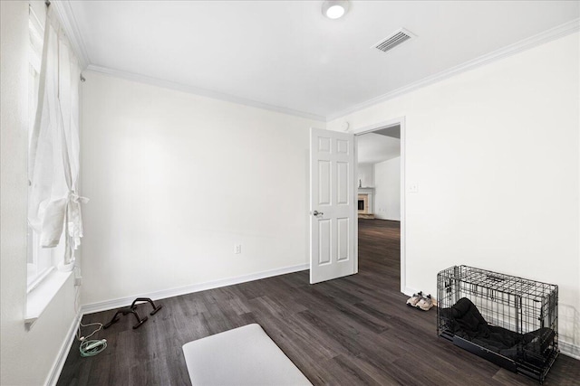 3928 Mesa Rd, Destin, FL 32541 - spare room featuring dark wood-style floors, crown molding, and a fireplace