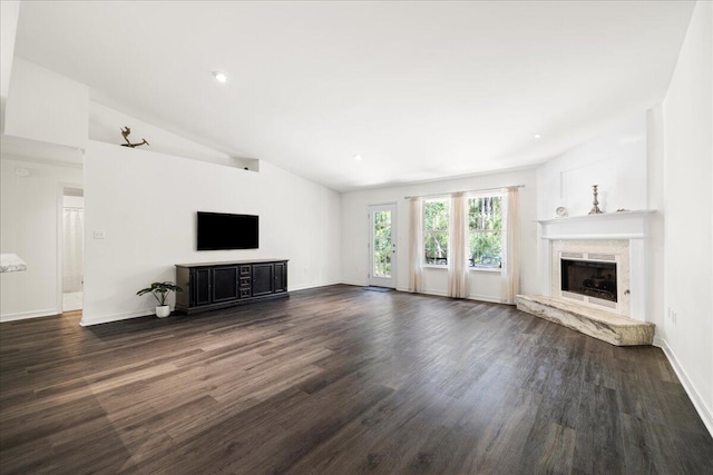 3928 Mesa Rd, Destin, FL 32541 - unfurnished living room featuring a premium fireplace, dark wood-style flooring, vaulted ceiling, and recessed lighting