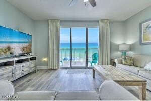 17757 Front Beach Rd Unit 507, Panama City Beach, FL 32413 - living room featuring wood finished floors, a water view, and a ceiling fan