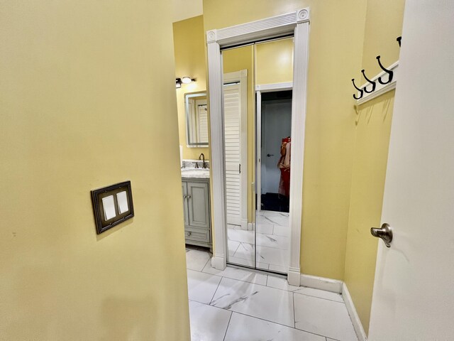 226 N Marsh Lndg, Freeport, FL 32439 - corridor featuring a sink and light marble finish floors