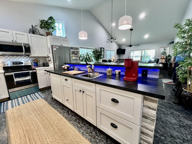 226 N Marsh Lndg, Freeport, FL 32439 - kitchen with stainless steel appliances, dark countertops, high vaulted ceiling, decorative backsplash, and white cabinetry