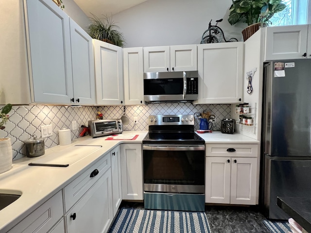 226 N Marsh Lndg, Freeport, FL 32439 - kitchen featuring stainless steel appliances, light countertops, decorative backsplash, and white cabinets