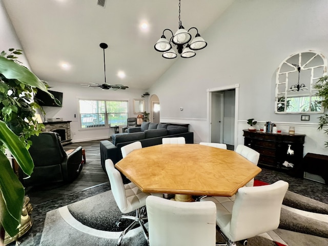 226 N Marsh Lndg, Freeport, FL 32439 - dining room featuring a chandelier, ceiling fan, high vaulted ceiling, arched walkways, and a fireplace