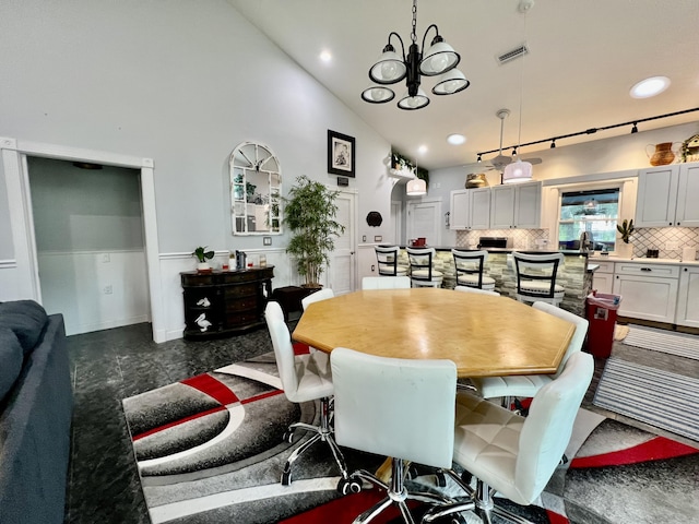 226 N Marsh Lndg, Freeport, FL 32439 - dining room with high vaulted ceiling, a chandelier, arched walkways, and recessed lighting