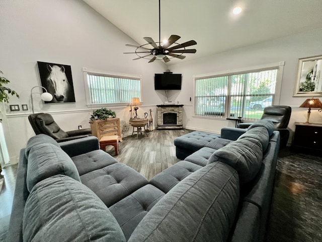 226 N Marsh Lndg, Freeport, FL 32439 - living area featuring a stone fireplace, ceiling fan, plenty of natural light, wood finished floors, and high vaulted ceiling