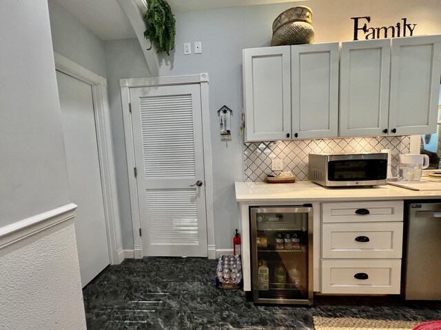 226 N Marsh Lndg, Freeport, FL 32439 - bar area featuring beverage cooler, stainless steel appliances, and decorative backsplash