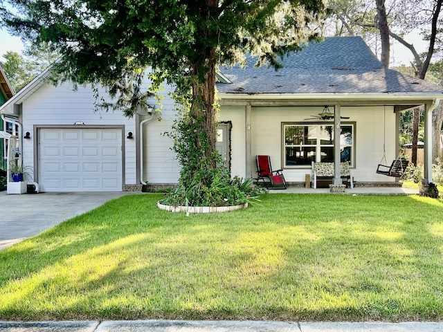 226 N Marsh Lndg, Freeport, FL 32439 - view of front of property with a front lawn, driveway, a ceiling fan, and a garage