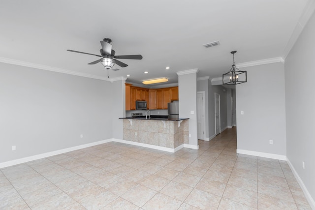 289 Mattie M Kelly Blvd, Destin, FL 32541 - kitchen featuring appliances with stainless steel finishes, dark countertops, crown molding, ceiling fan, and brown cabinetry