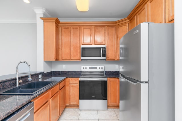 289 Mattie M Kelly Blvd, Destin, FL 32541 - kitchen featuring appliances with stainless steel finishes, crown molding, light tile patterned floors, dark stone countertops, and recessed lighting