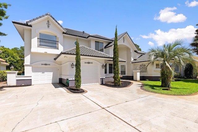 96 Garnet Pl, Destin, FL 32541 - mediterranean / spanish home featuring a balcony, stucco siding, a tiled roof, driveway, and a garage
