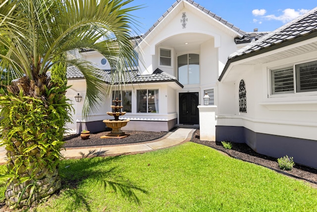 96 Garnet Pl, Destin, FL 32541 - view of front of home featuring a tile roof, a front lawn, and stucco siding