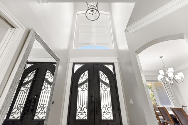 96 Garnet Pl, Destin, FL 32541 - entryway with french doors, a chandelier, arched walkways, and ornamental molding