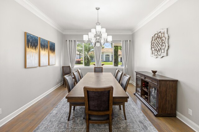96 Garnet Pl, Destin, FL 32541 - dining area featuring a chandelier, wood finished floors, and crown molding