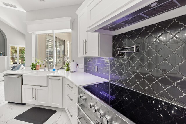 96 Garnet Pl, Destin, FL 32541 - kitchen featuring ventilation hood, stainless steel dishwasher, stove, arched walkways, and decorative backsplash